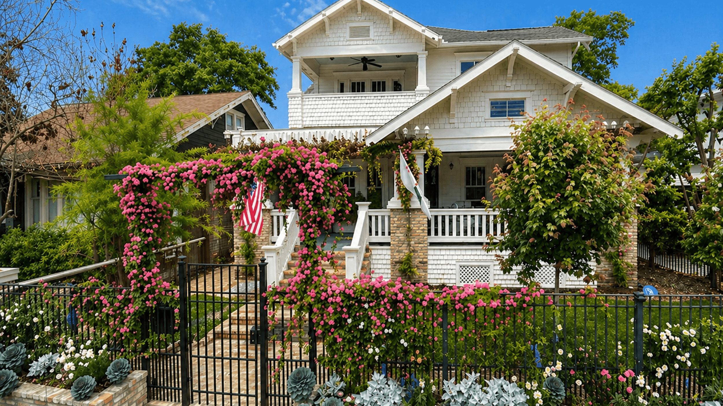 Designed front-yard rose garden with an entry gate and layered flower beds